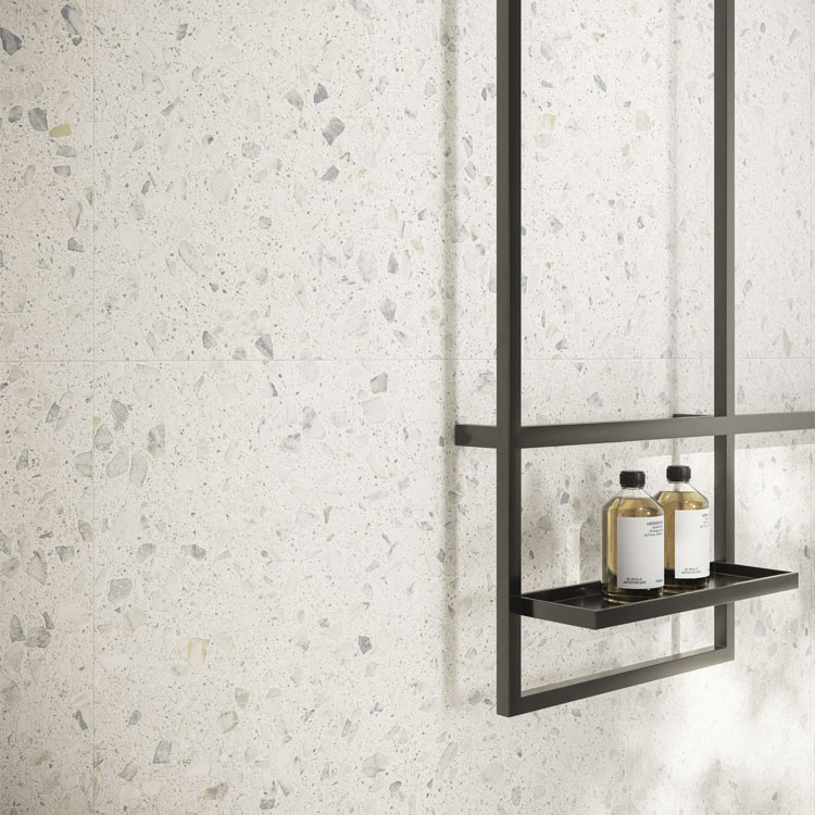 white with light grey and blue specks terrazzo tile on bathroom wall